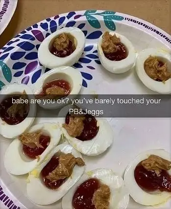 Picture of a plate of eggs of which the yolk was replaced by peanut butter and jam captioned "babe are you ok? you've barely touched PB&Jeggs"