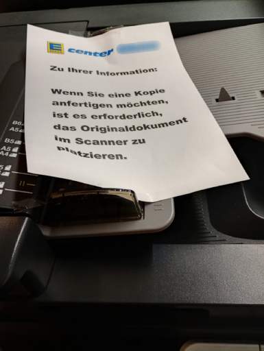 DIN A4-Zettel auf Drucker mit: "Wenn Sie eine Kopie anfertigen möchten, ist es erforderlich das Originaldokument im Scanner zu platzieren."